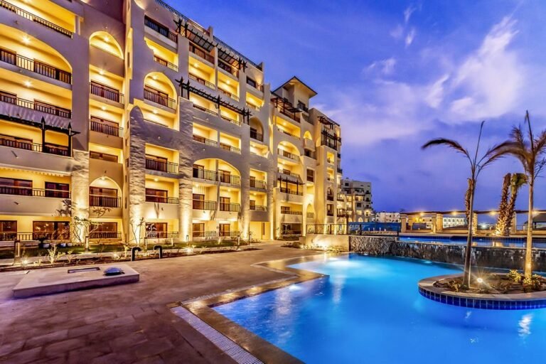 ALDAU Heights communal pool and buildings in the evening