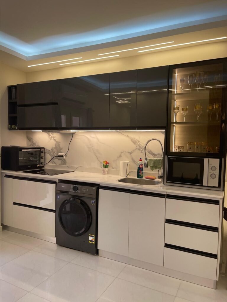 Fitted kitchen with dark wall cabinets and white lower cabinets